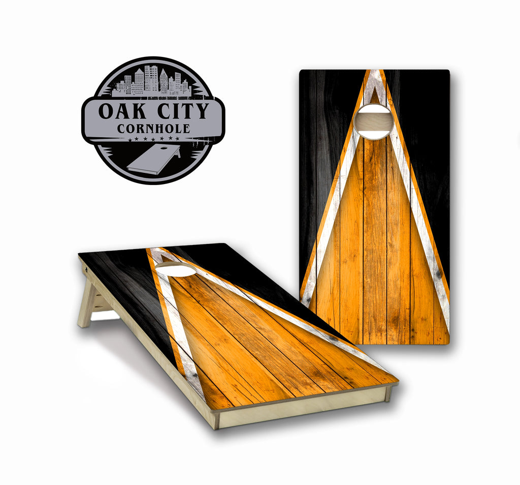 Custom regulation cornhole boards with an orange and black wood triangle pattern design.