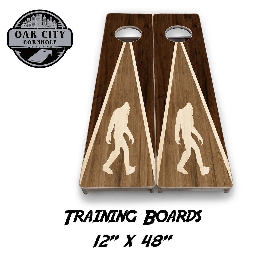 Bigfoot Adventure Cornhole Boards by Oak City Cornhole featuring a striking silhouette of Bigfoot on a beautifully crafted wood design. Premium handcrafted 24"x48" regulation boards made from high-quality Baltic birch plywood, perfect for cornhole enthusiasts and serious players.