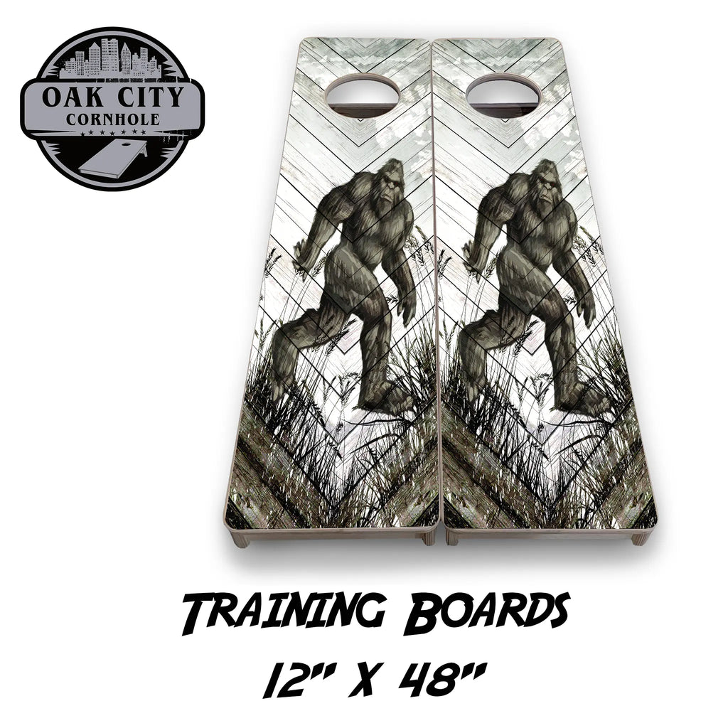 Bigfoot Encounter Cornhole Boards by Oak City Cornhole featuring a dramatic depiction of Bigfoot against a rustic, weathered wood backdrop. Premium handcrafted 24"x48" regulation boards made from high-quality Baltic birch plywood, perfect for competitive gameplay and outdoor gatherings.