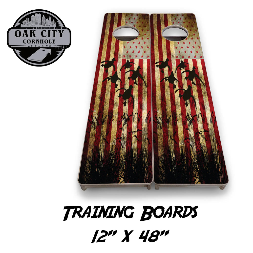 Patriotic Red Flag Duck Hunter Cornhole Boards from Oak City Cornhole, featuring a vibrant duck hunting scene with American flag accents.