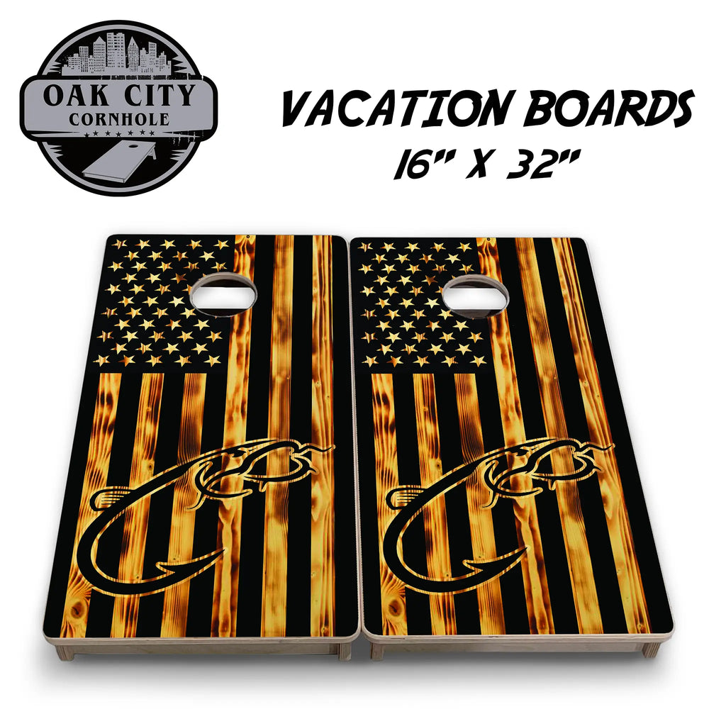 Wood-burned American flag cornhole board with a striking silhouette of a catfish and hook design.